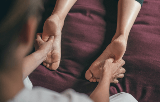 Chiropractor holding a patient's feet.