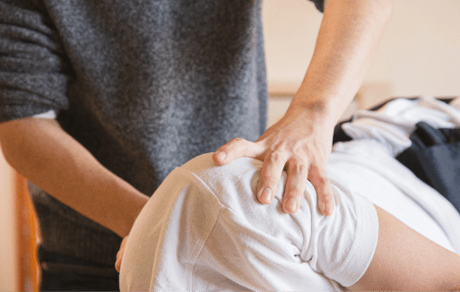 Chiropractor adjusting a patient's shoulder.